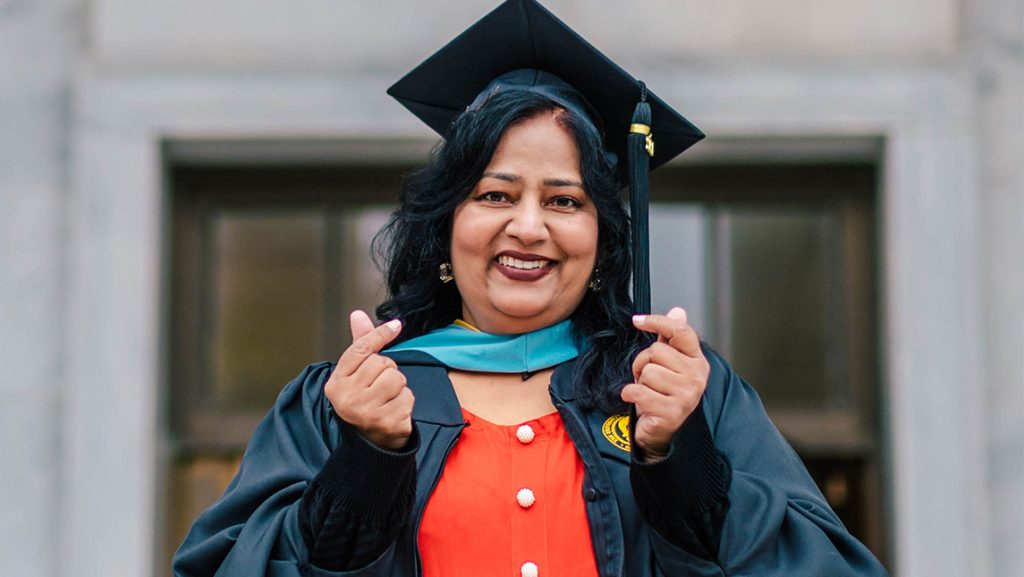 Rabia Qindeel wearing her UNCG cap and gown.