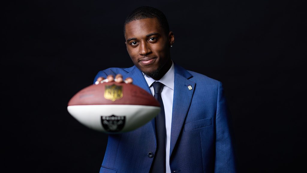 Desmond Moore holds a football.
