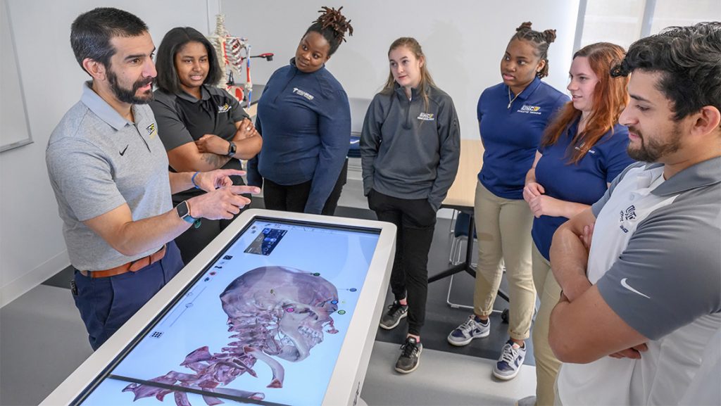 UNCG's Dr. Aaron Terranova shows students a virtual diagram of the human skull.