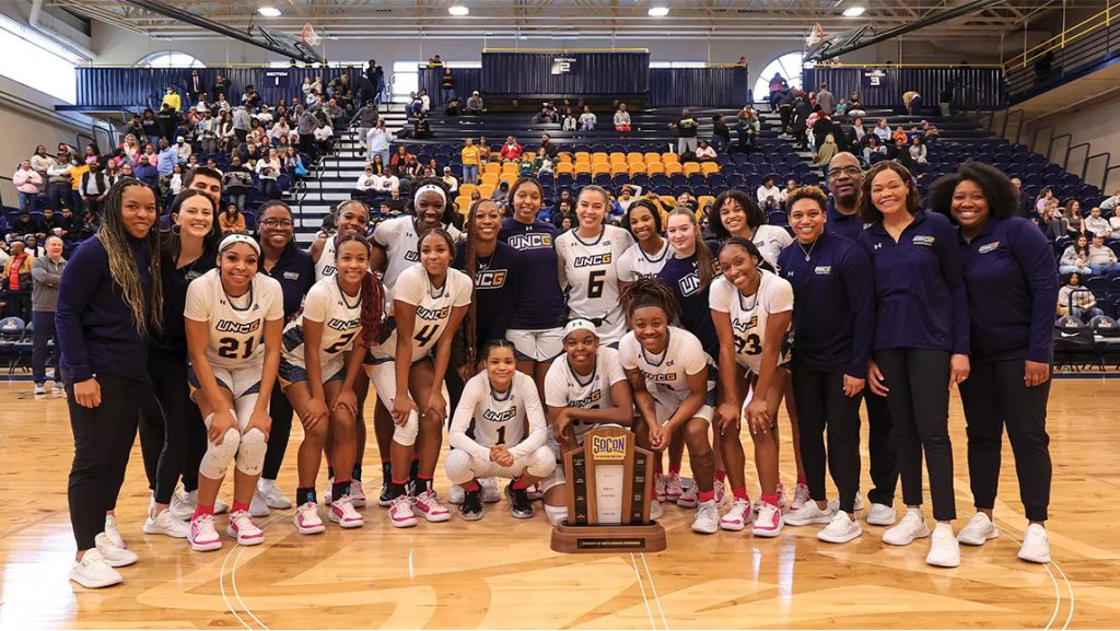 team posing with trophy