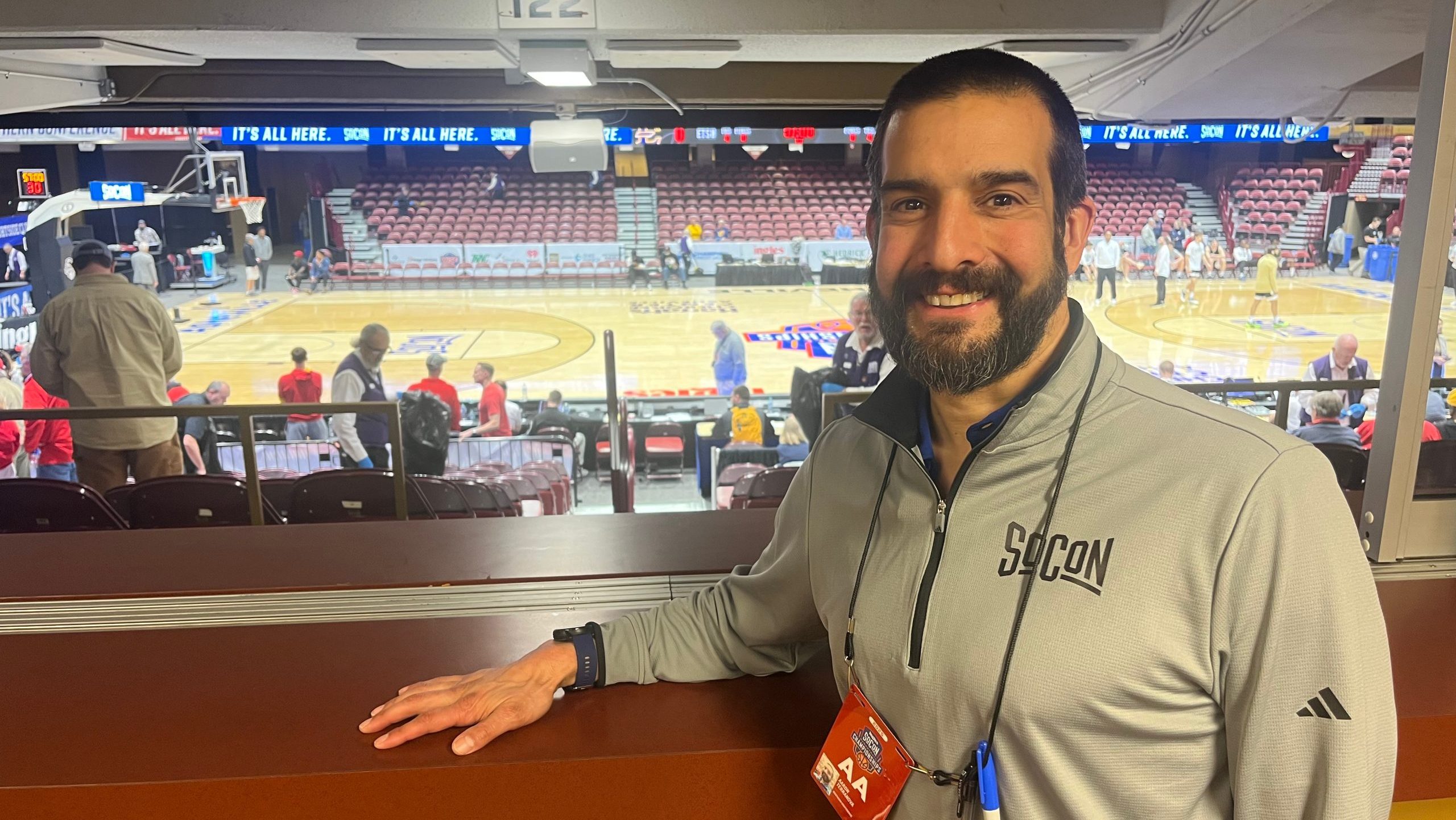 Dr. Aaron Terranova overlooks the SoCon Tournament basketball court at Harrah's Cherokee Center.