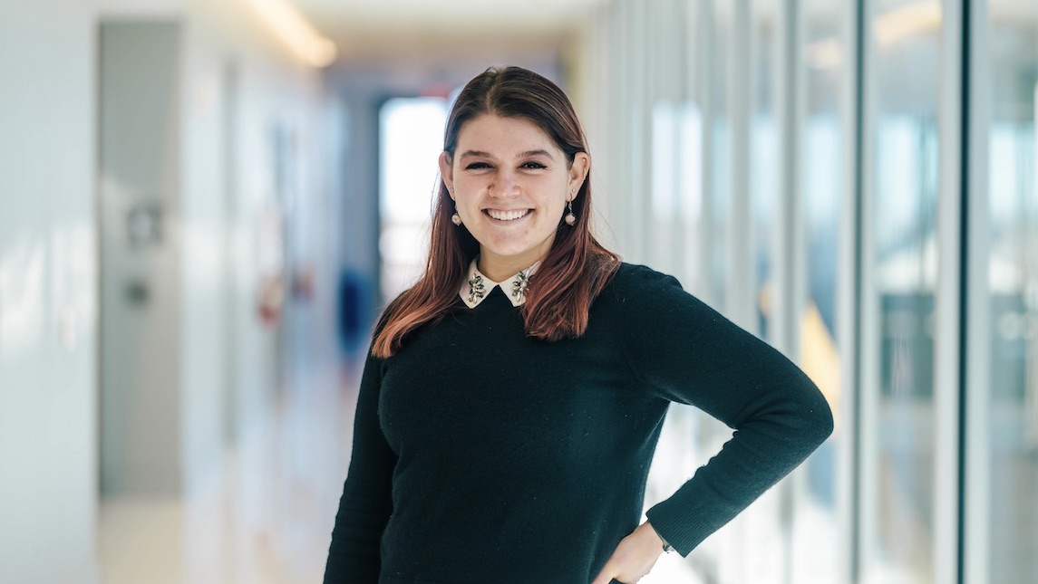School of Nursing staff member posing in hallway of the school of nursing.