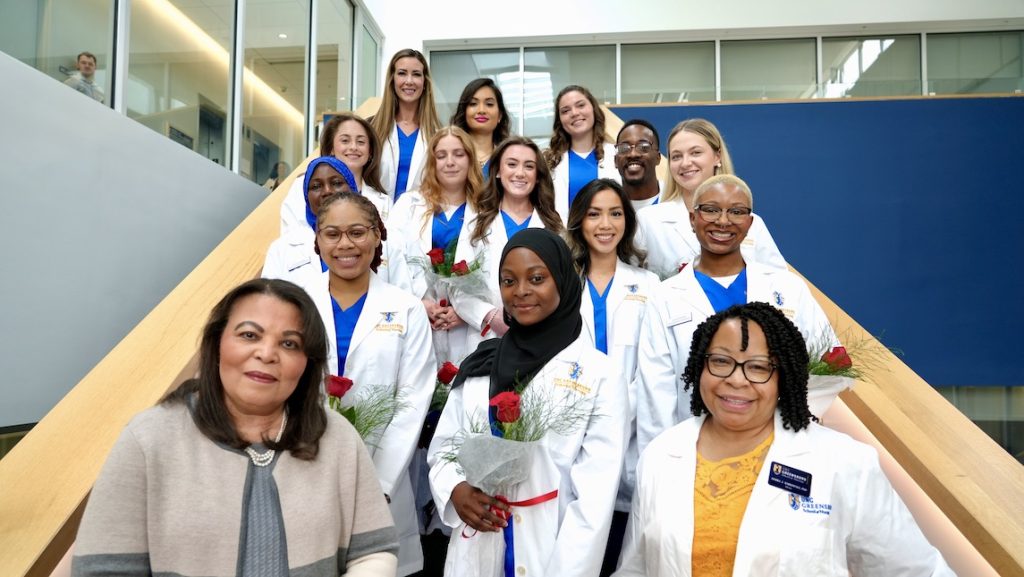 School of Nursing students gather on the the steps of UNCG after white coat ceremony.