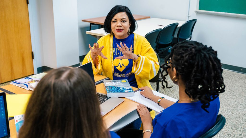 UNCG Dr. Jeannette Wade speaks to two of her students.