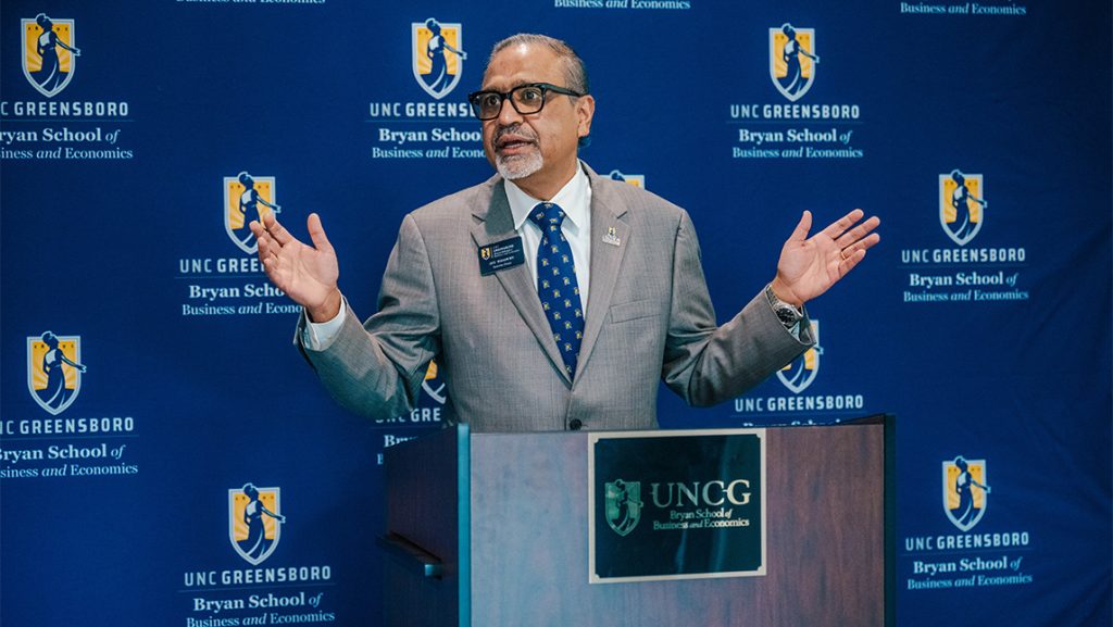Dr. Joy Bhadury at a podium.