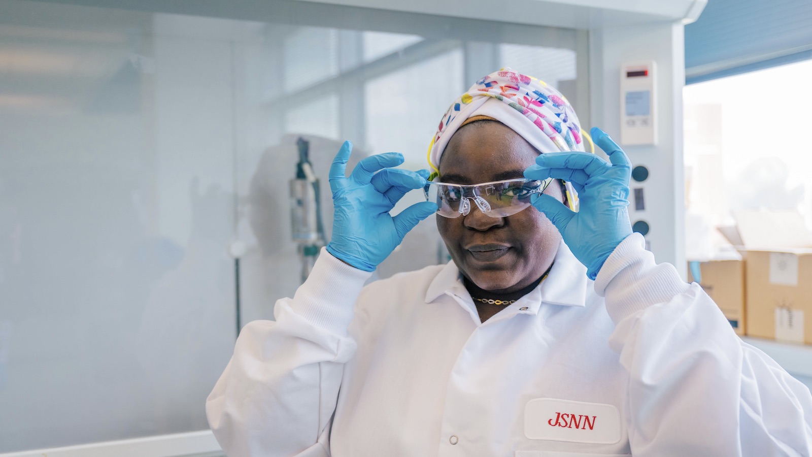 JSNN student putting on safety googles in the lab.