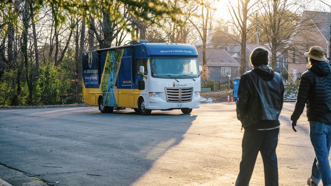 UNCG School of Nursing Minerva Mobile Health Unit parked in a parking lot.