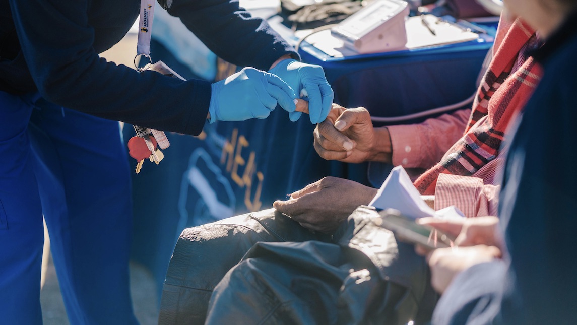 Minerva Mobile nurses helping a patient. 