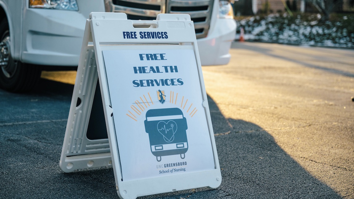 Minerva Mobile Health sign welcomes patients with free health services.