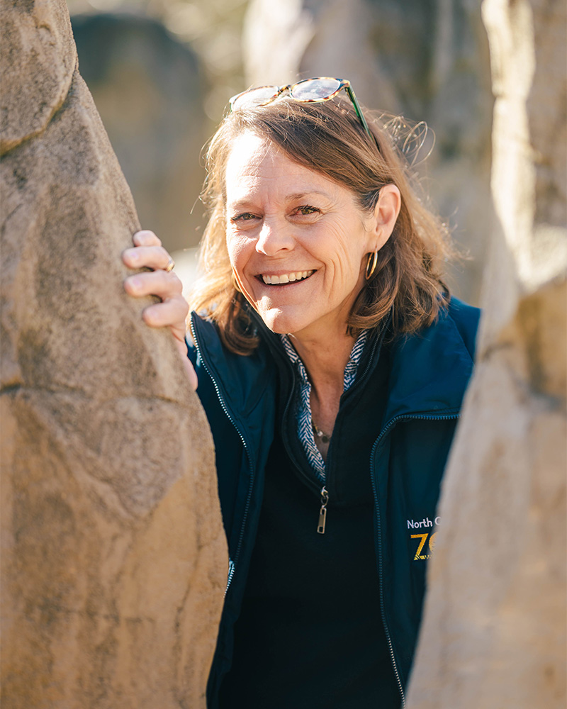 Crista McGee peeks between two rocks in the Kidzone maze.