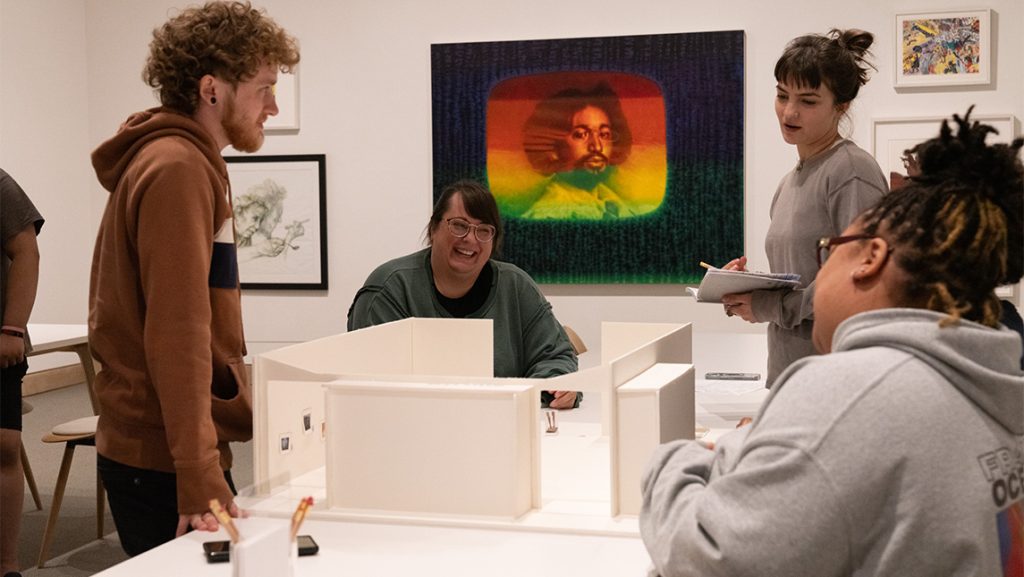 Students gather around a building model in a UNCG art history class.