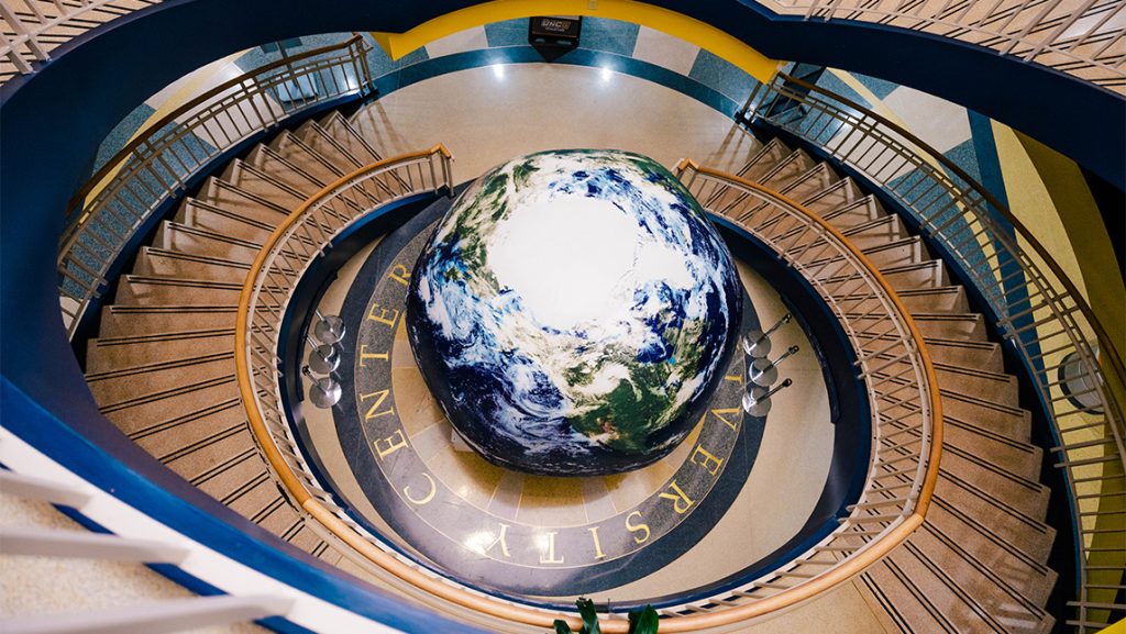 Giant earth globe in between winding staircases at UNCG.