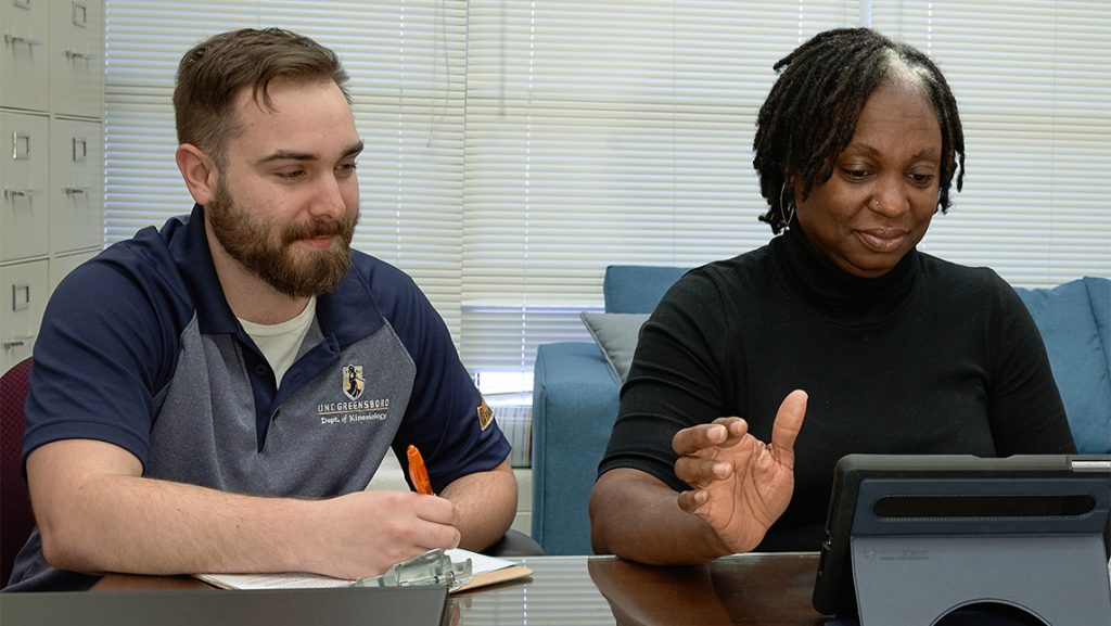 A UNCG kinesiology watches a test participant.