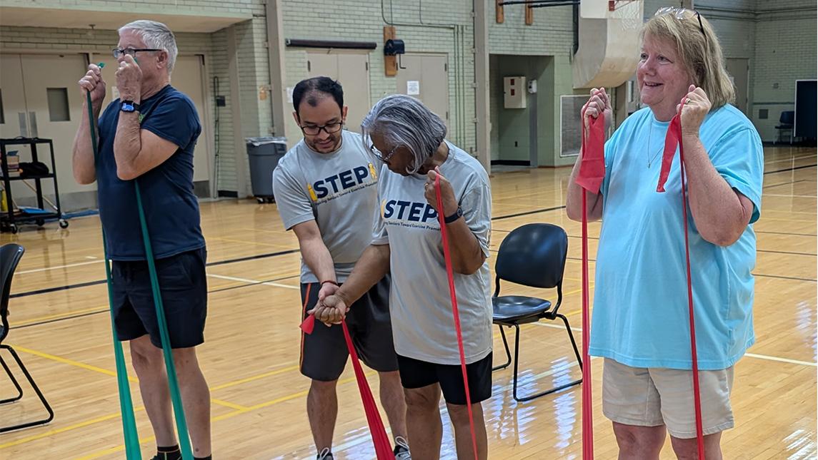UNCG kinesiology students leads senior citizens in grip resistence exercises.
