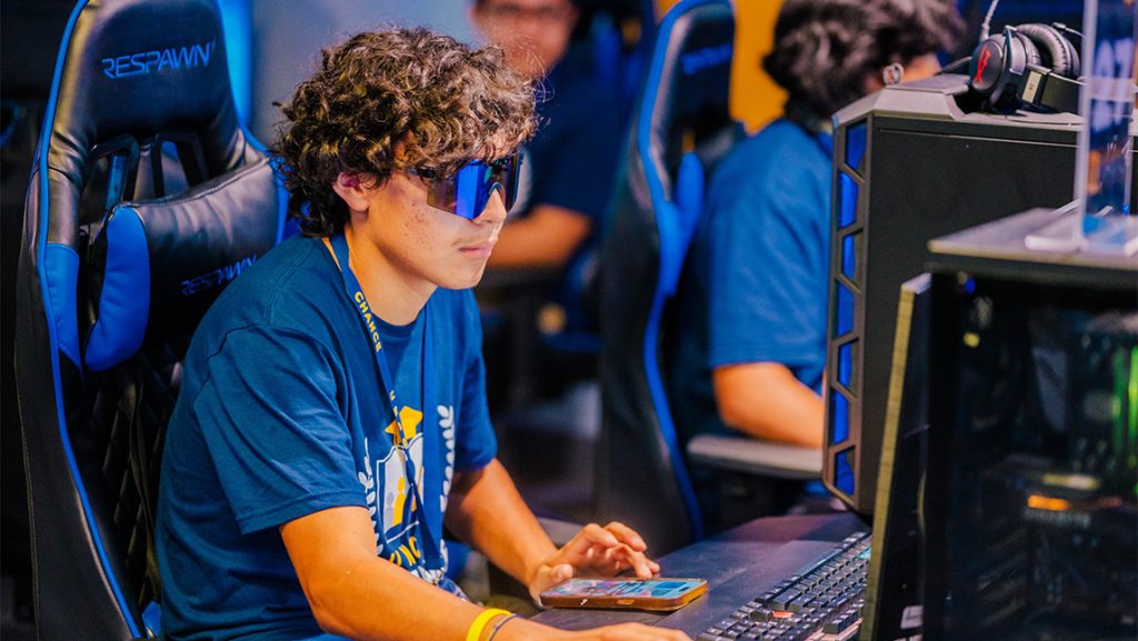 A boy plays video games at UNCG.