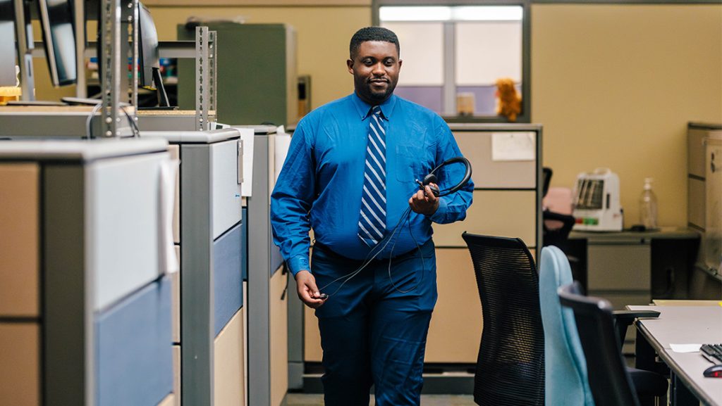 Zion Turner walks through the UNCG ITS office.