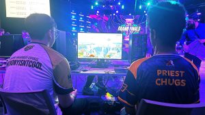 UNCG esports players playing in front of a console.