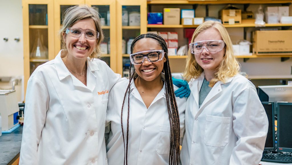 Janae Wofford in the lab with UNCG Professor Nadja Cech and doctoral student Zoie Bunch.