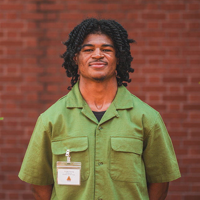 Student poses with a Humanities at Work name tag.