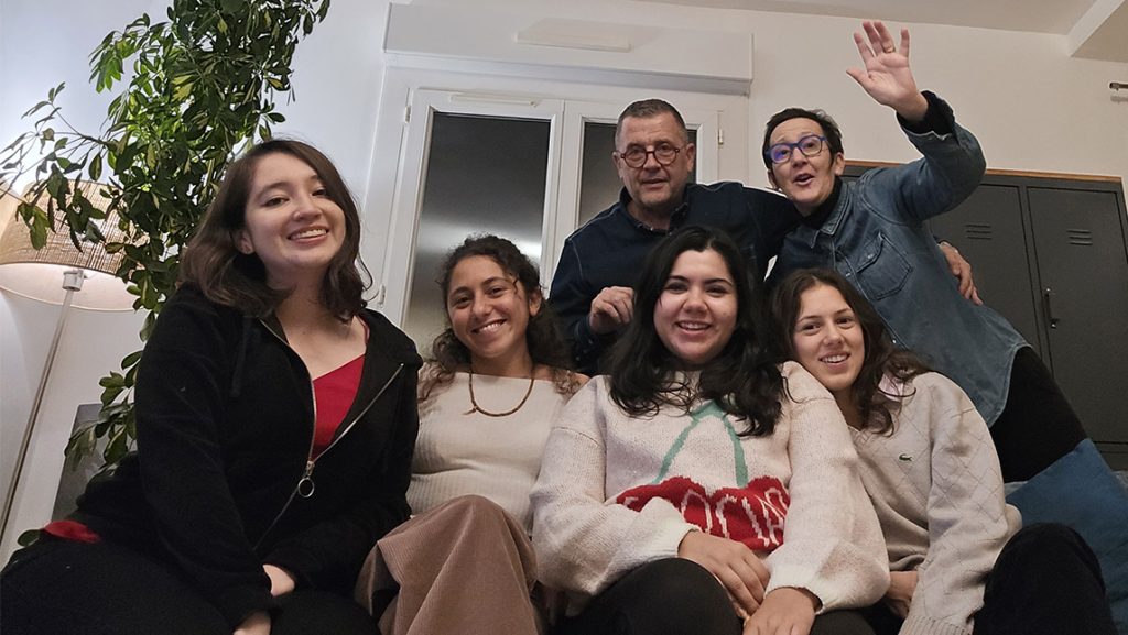 UNCG alumna Grecia Nandin eating a Thanksgiving dinner with teaching assistants in France.