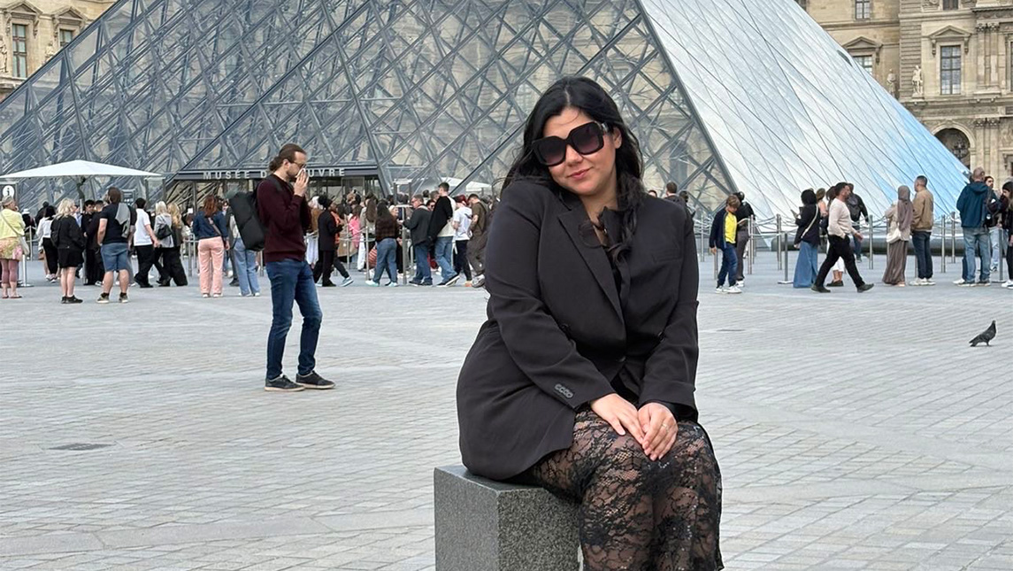 UNCG alumna Grecia Nandin poses outside the Louvre.