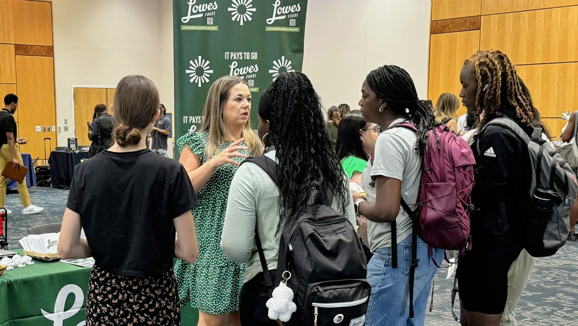 UNCG students talk with a representative from Lowes Foods.