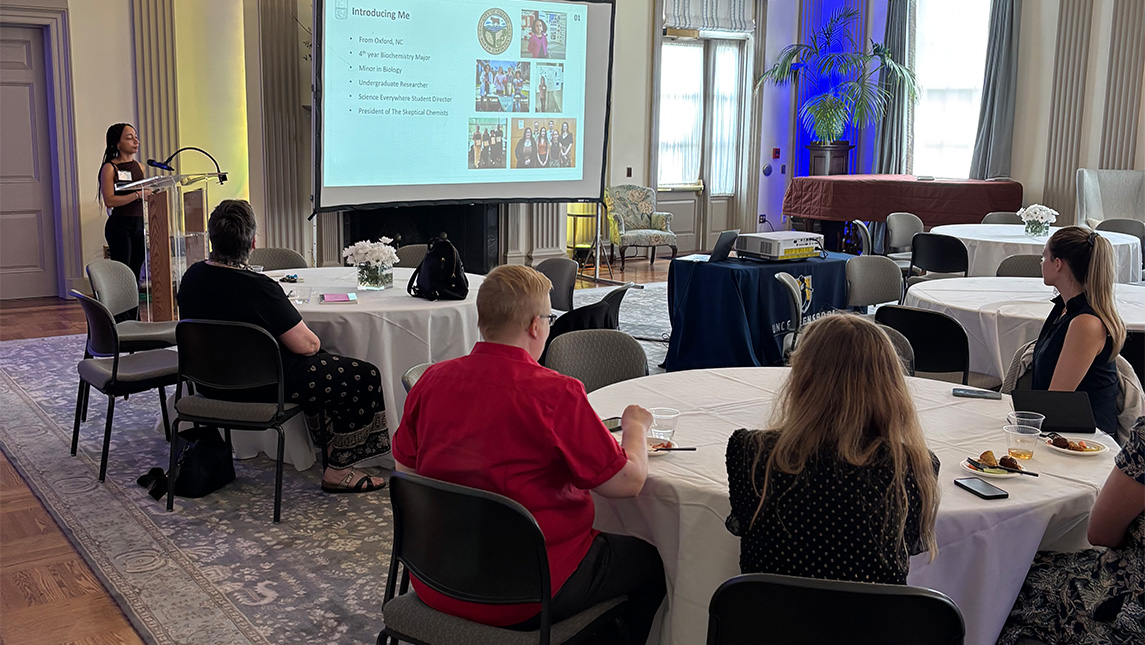 UNCG student Jasmin Grillo gives a powerpoint presentation.