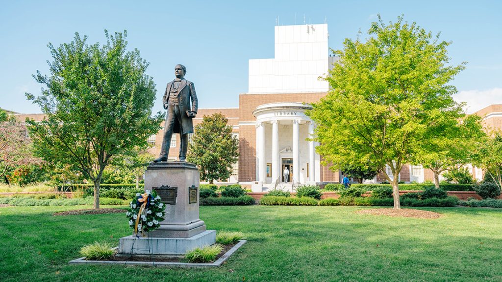 Beauty shot of the McIver statue in front of Jackson library with a wreath adorning it for Founders Day.