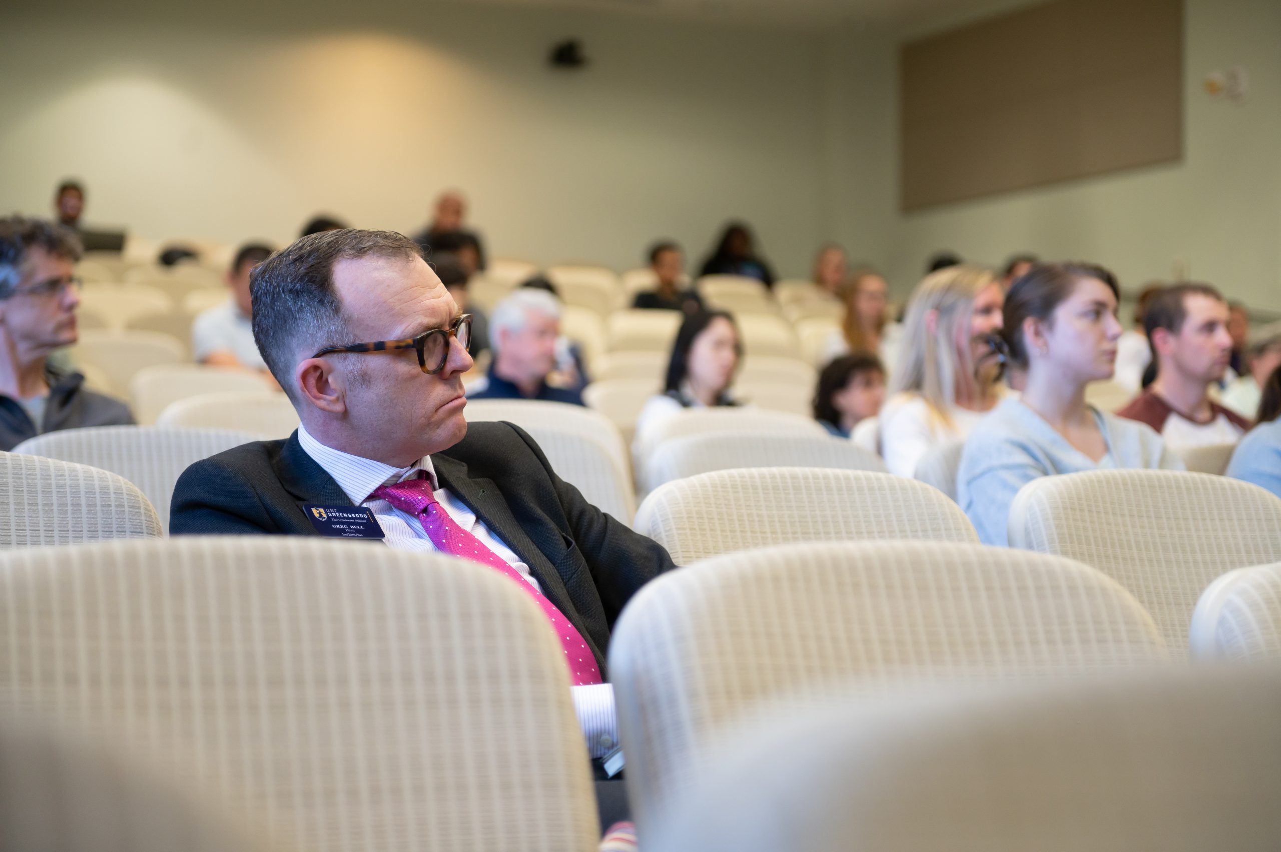 lecture stock imagery of people in the audience engaged in the lecture