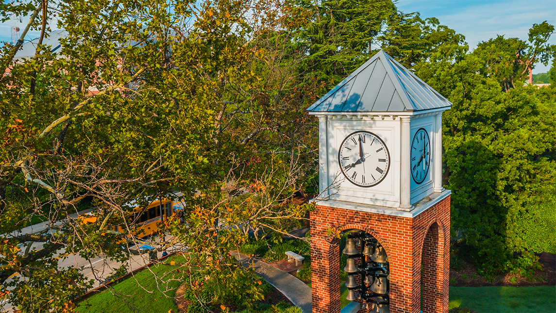 UNCG Vacc clock tower as leaves start to change color.