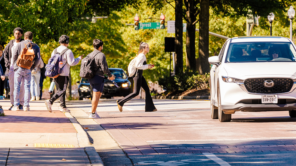 Students cross the street outside UNCG.