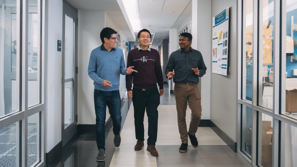 Three new JSNN Nanoscience faculty: Dr. Oscar Avalos Ovando, Dr. Sampath Gamage, and Dr. Tianqi Song walking down the hallway.