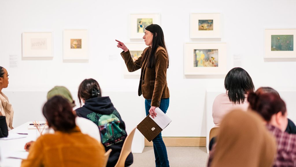 UNCG Professor Heather Holian explains animation cels to students.