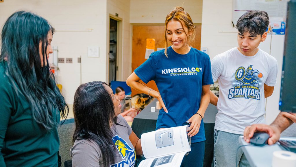UNCG students chat amongst themselves during research.