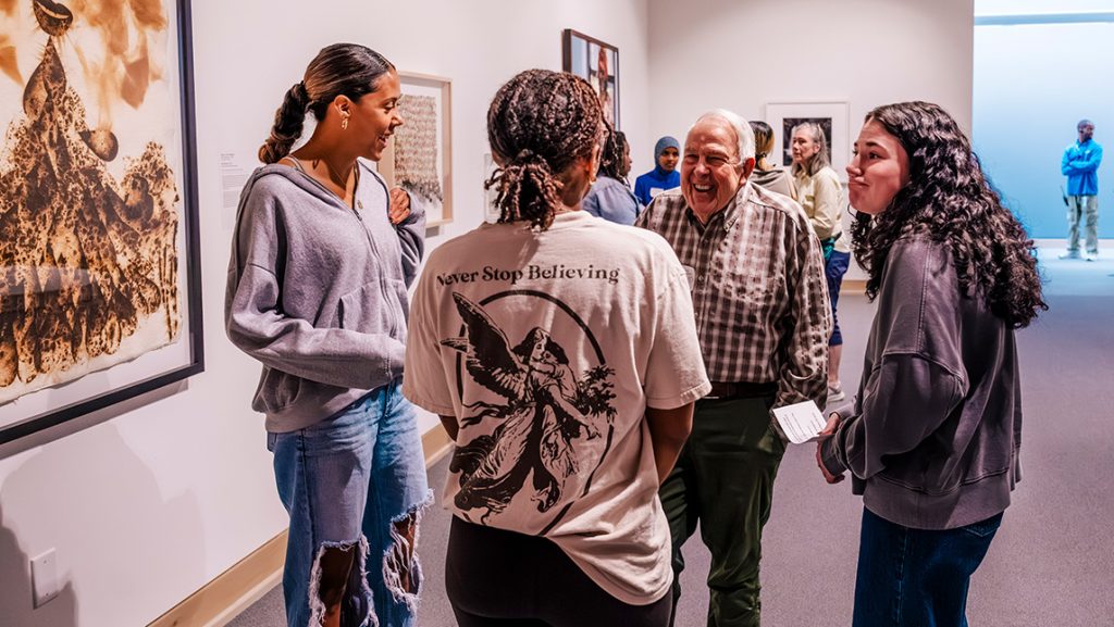 UNCG students talk to a senior citizen.
