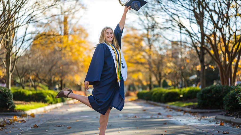 UNCG graduate Maddy Gilhool shows off her cap.