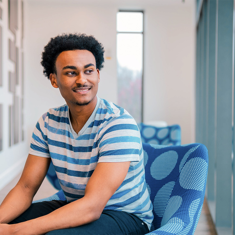 UNCG student Malcolm Johnson looks out a window.