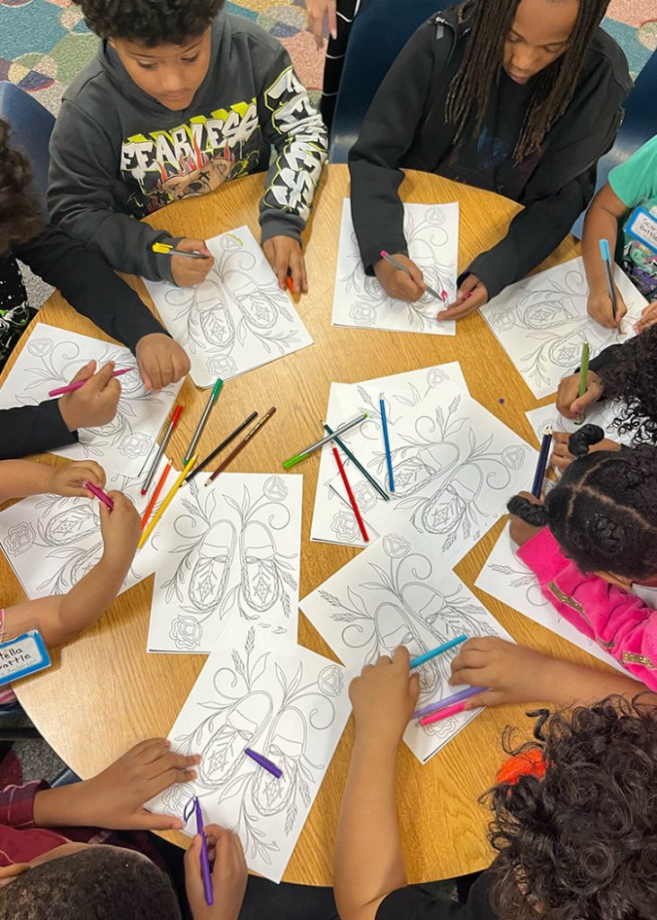 Children color in a book.