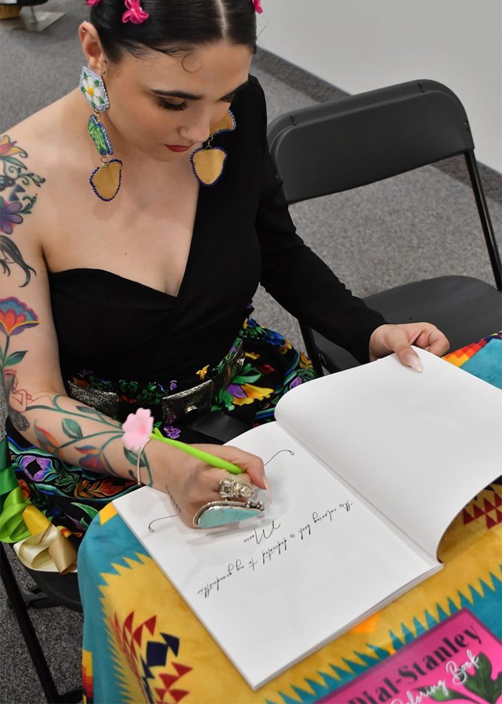 Raven Dial-Stanley signs books.