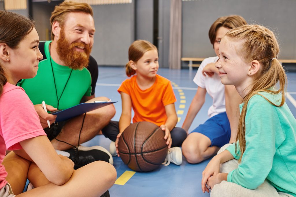 Students sit with a male teacher