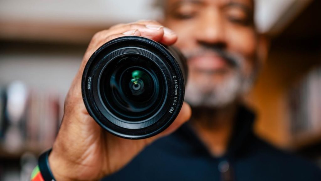 Tony L. Patterson posing with a lens