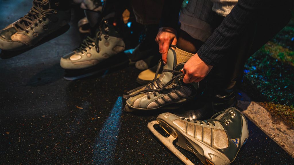 UNCG students lace up ice skates.