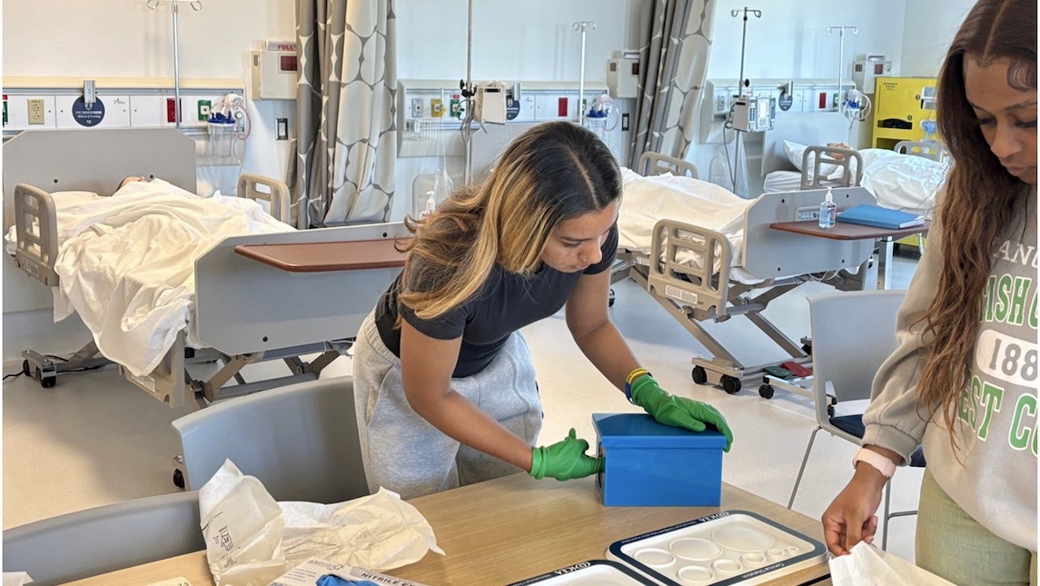 UNCG School of Nursing students working together in the lab.