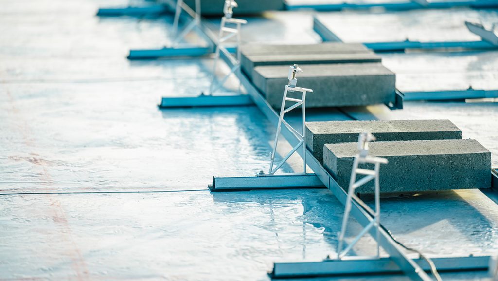 Workers install solar panels on UNCG Middle College roof.