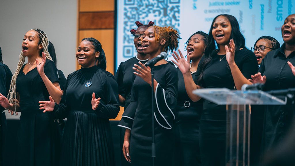 A choir performs on stage.