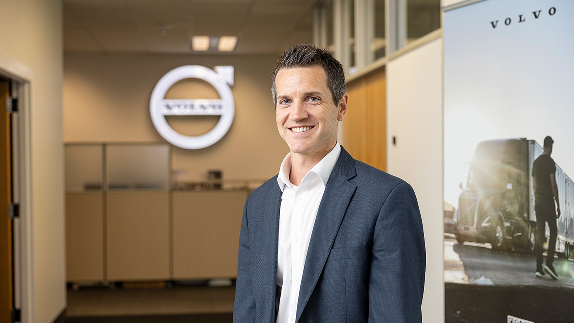 Luke McGalliard, UNCG alum, at the Volvo office.