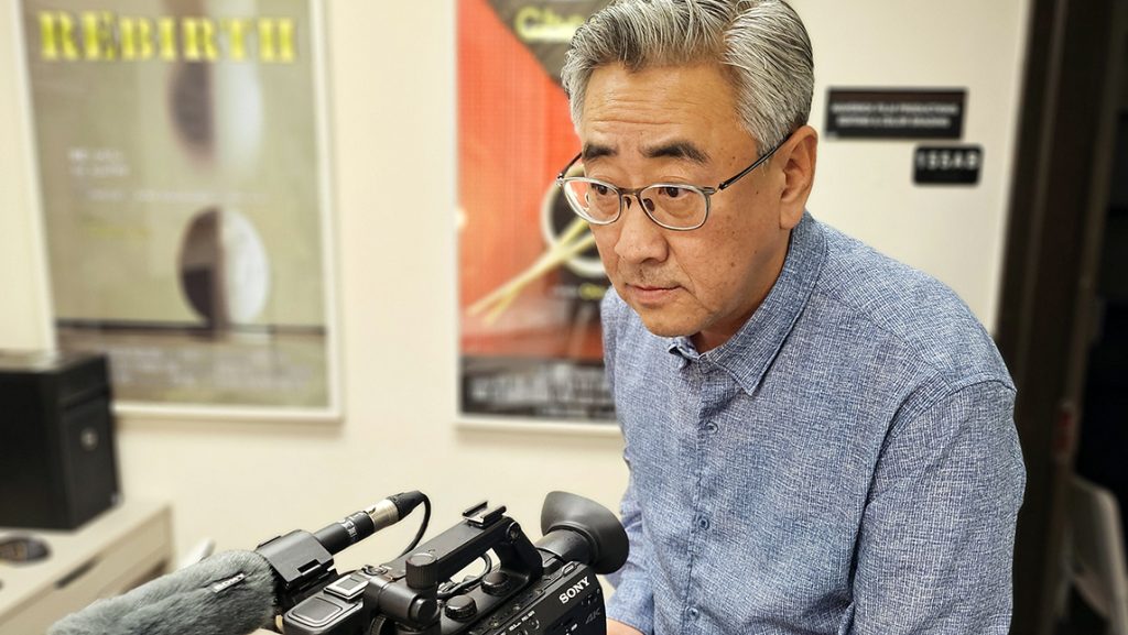 Changee Chun with a video camera.