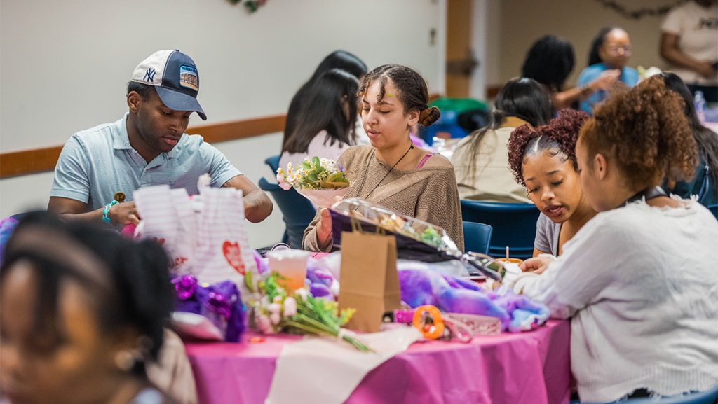 UNCG students work on Valentine's Day-themed crafts.
