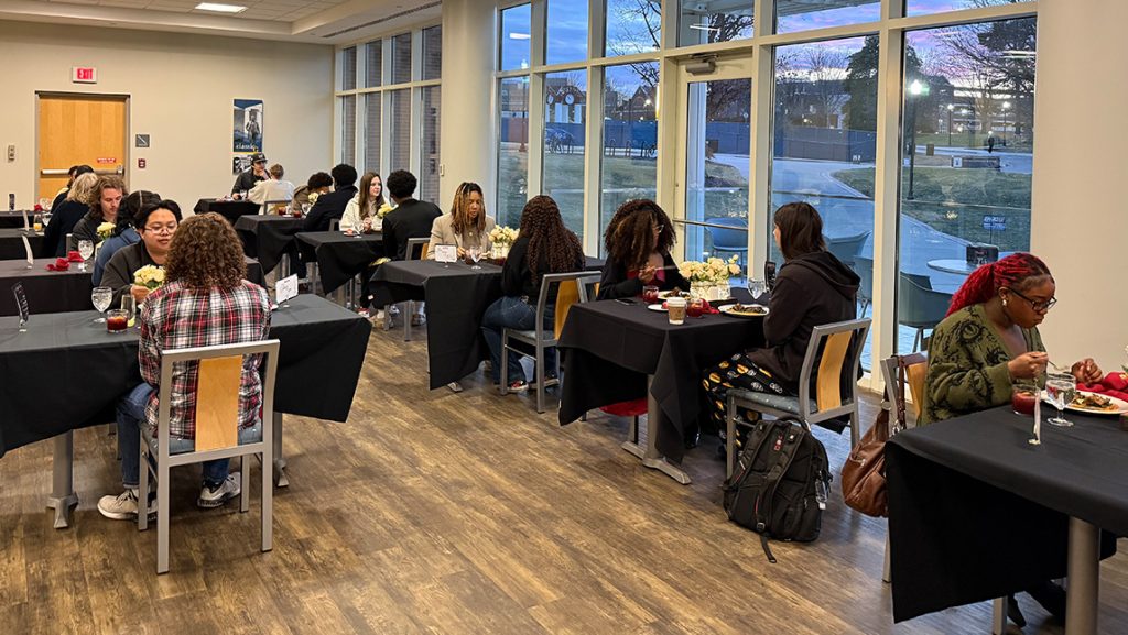 UNCG students eat at a Paris-themed dinner.
