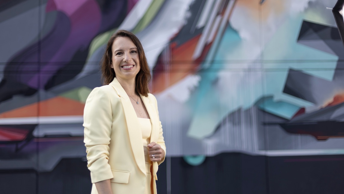 Marketa Rickley of UNCG BSBE stands on front of a colorful background.